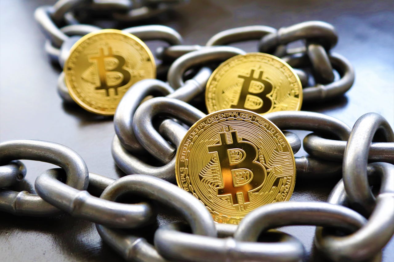 Close-up of Bitcoin coins entwined in metallic chains showcasing cryptocurrency security.